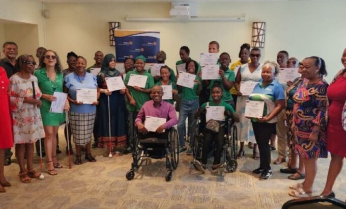 Programme Manager of the People Development Implementation and Monitoring Unit, Erika Watson (right), poses with participants of the AccessAbility: Pathways to Independence Programme workshop and officials at today’s closing ceremony. (P. Harper-Grant|BGIS)