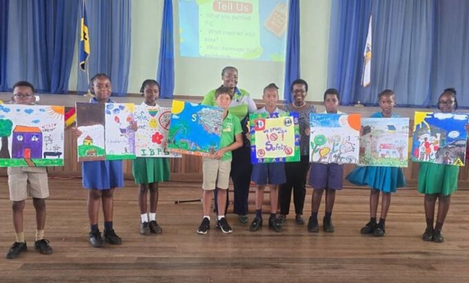 Members of the National Child Labour Committee, Naketa Wiggins (back row, left) and Rhonda Farley, pose with students displaying their art work highlighting the dangers of child labour. (P. Harper-Grant|BGIS)
